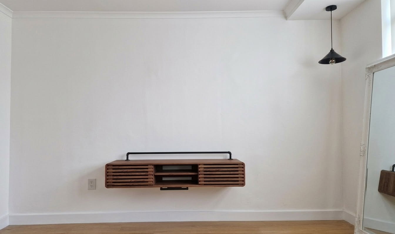 Blank white living room wall with a floating console before the mural